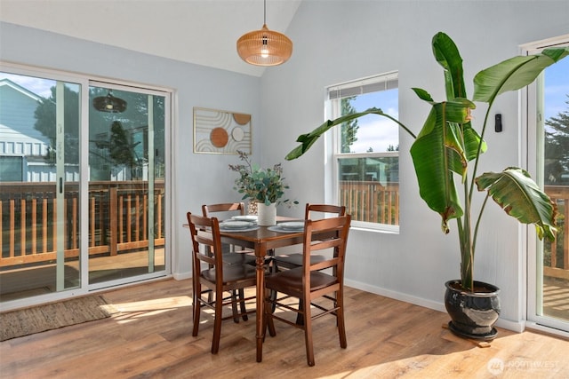 585 Ocean Shores Blvd SW, Ocean Shores, WA 98569 - dining room featuring wood finished floors, baseboards, and high vaulted ceiling
