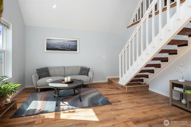 585 Ocean Shores Blvd SW, Ocean Shores, WA 98569 - living room featuring vaulted ceiling, stairway, baseboards, and wood finished floors