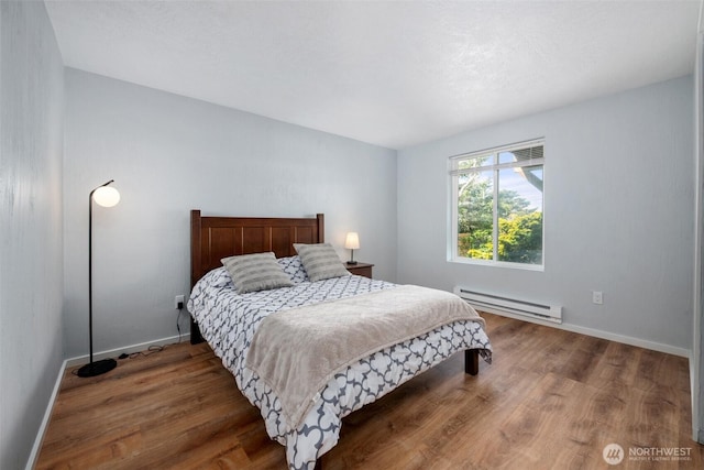 585 Ocean Shores Blvd SW, Ocean Shores, WA 98569 - bedroom with a baseboard radiator, wood finished floors, and baseboards