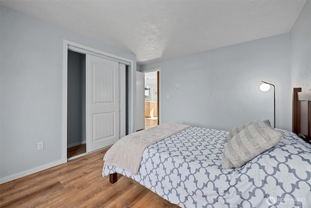 585 Ocean Shores Blvd SW, Ocean Shores, WA 98569 - bedroom featuring wood finished floors, baseboards, and a closet