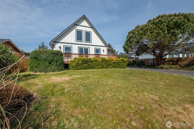 585 Ocean Shores Blvd SW, Ocean Shores, WA 98569 - rear view of house with a lawn, a deck, and board and batten siding