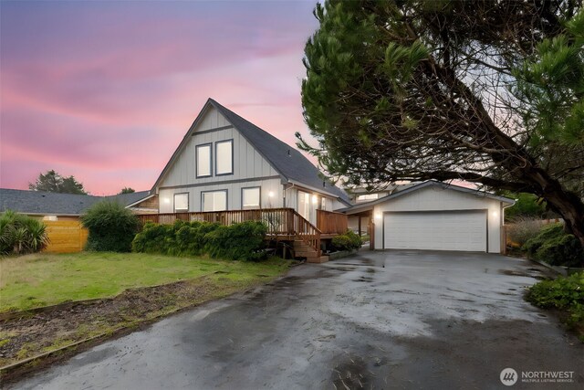 585 Ocean Shores Blvd SW, Ocean Shores, WA 98569 - view of front facade featuring a front lawn, a wooden deck, and a detached garage