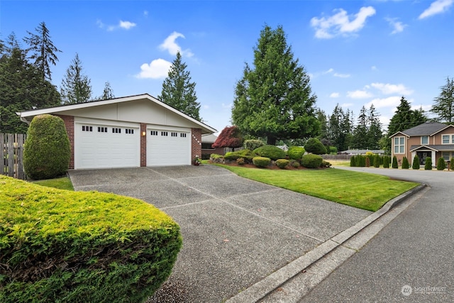 view of front of house featuring a front lawn and a garage