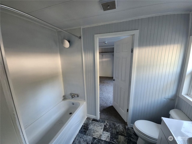 full bathroom with vanity, crown molding, wooden walls, toilet, and shower / bathtub combination