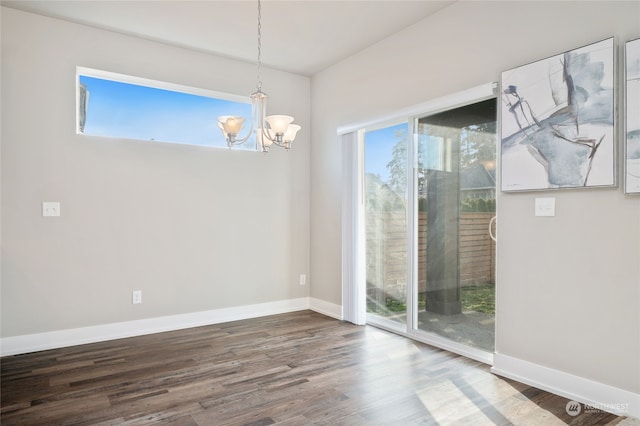 unfurnished dining area with a wealth of natural light, a chandelier, and wood-type flooring