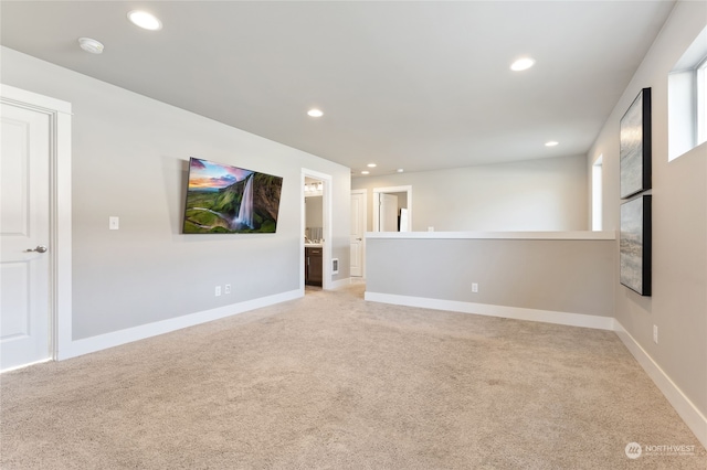 unfurnished living room featuring light carpet