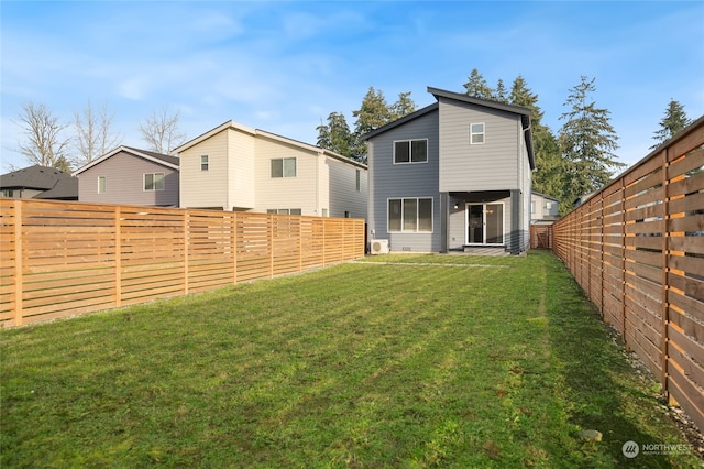 rear view of property featuring a yard