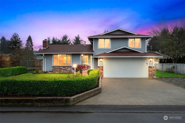 view of front of property with a yard and a garage