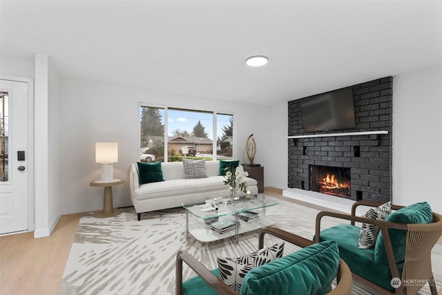 living room featuring a fireplace and light hardwood / wood-style flooring