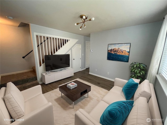 living room with hardwood / wood-style floors and a notable chandelier