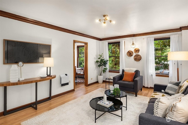 living room with heating unit, light hardwood / wood-style flooring, and ornamental molding