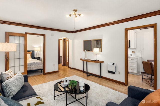 living room featuring light hardwood / wood-style floors, heating unit, and ornamental molding