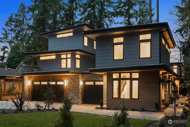 modern home featuring a garage and a front lawn