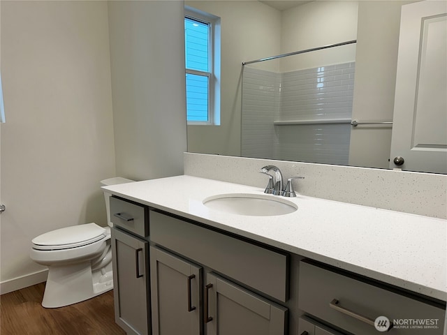 13628 187th St E Unit 36, Puyallup, WA 98374 - bathroom with wood finished floors, vanity, toilet, a shower, and baseboards