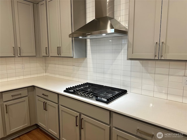 13628 187th St E Unit 36, Puyallup, WA 98374 - kitchen featuring wall chimney exhaust hood, stainless steel gas cooktop, and gray cabinets