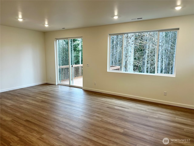 13628 187th St E Unit 36, Puyallup, WA 98374 - empty room with wood finished floors, baseboards, and recessed lighting