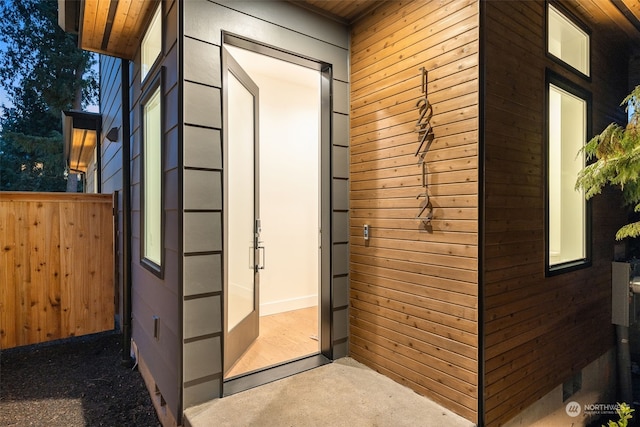 interior space featuring wooden ceiling and wooden walls