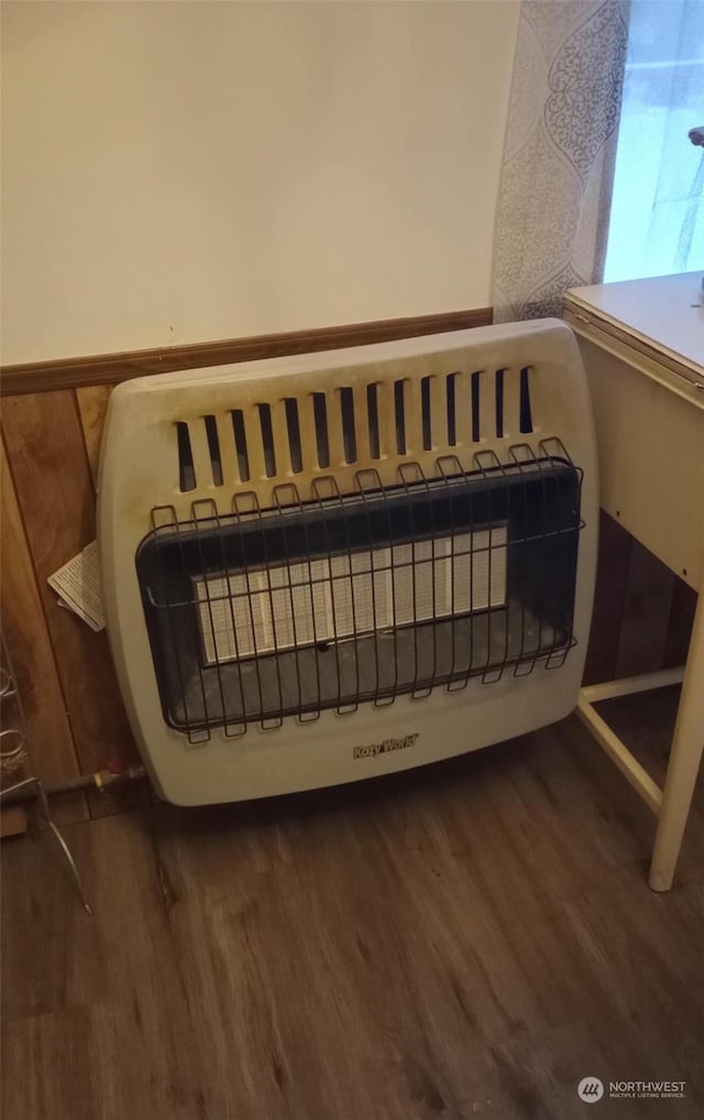 room details with wood-type flooring and heating unit