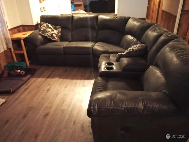 living room with wooden walls and wood-type flooring