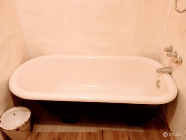 bathroom featuring a washtub and wood-type flooring