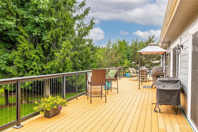 wooden terrace with a gazebo and grilling area