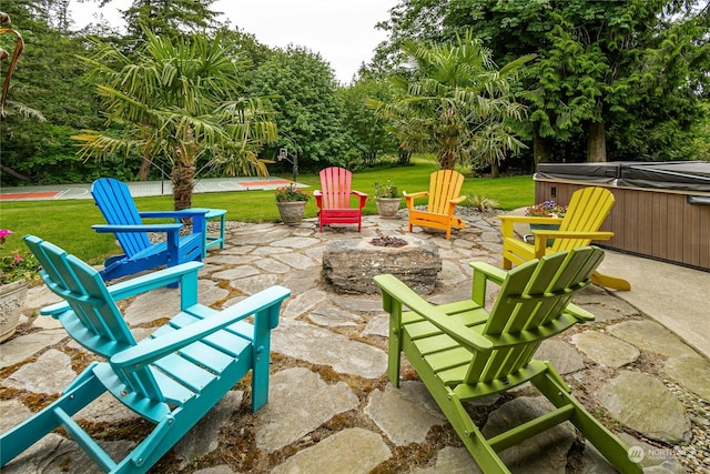 view of patio featuring an outdoor fire pit and a hot tub