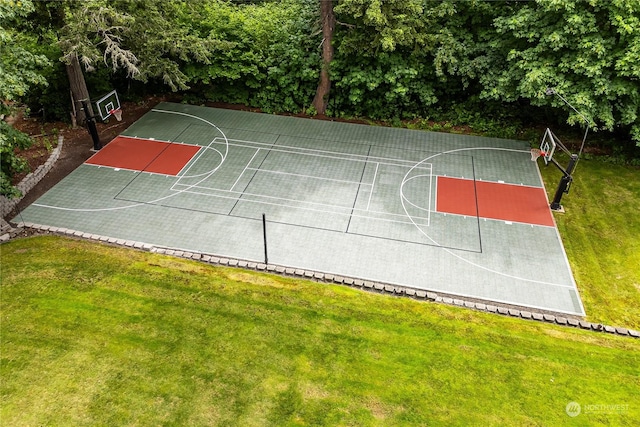 view of sport court with a lawn