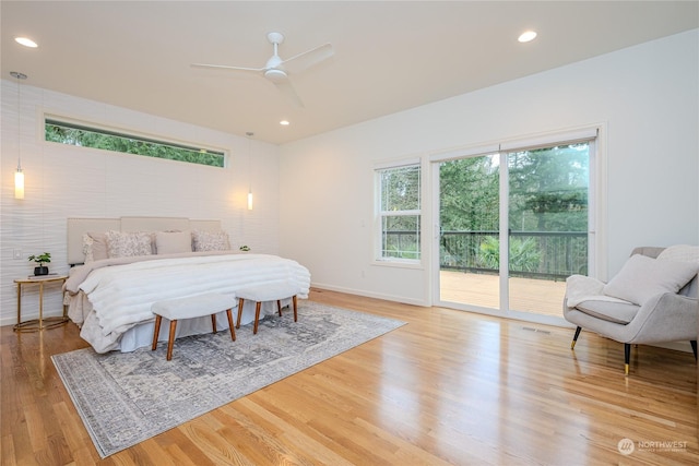 bedroom with ceiling fan, light hardwood / wood-style flooring, access to outside, and multiple windows