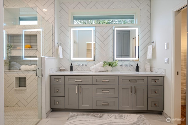 bathroom featuring walk in shower, tile patterned flooring, and vanity