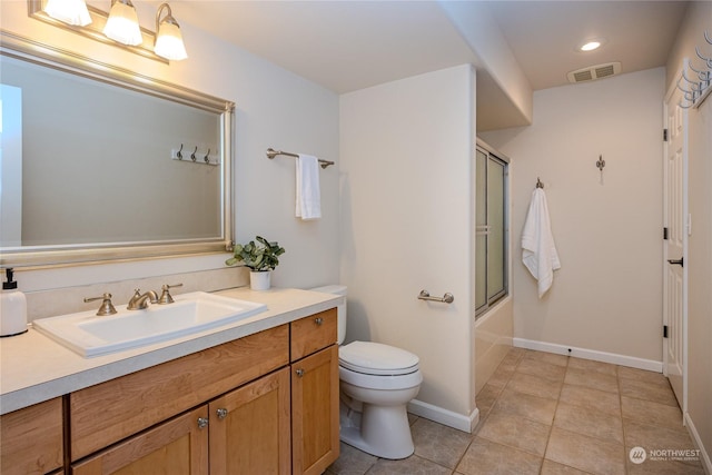 full bathroom featuring toilet, combined bath / shower with glass door, tile patterned flooring, and vanity