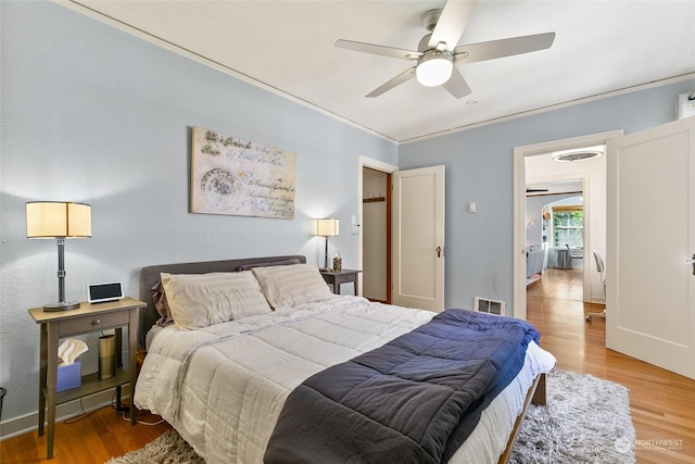 bedroom with wood-type flooring and ceiling fan