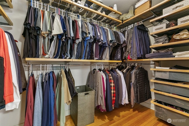 spacious closet featuring hardwood / wood-style flooring