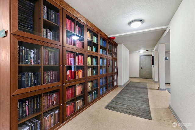 hallway with a textured ceiling