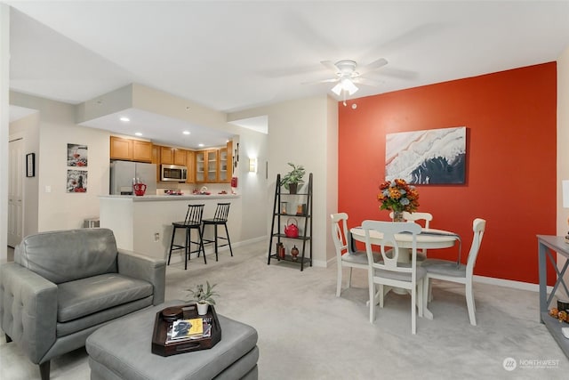 carpeted living room featuring ceiling fan