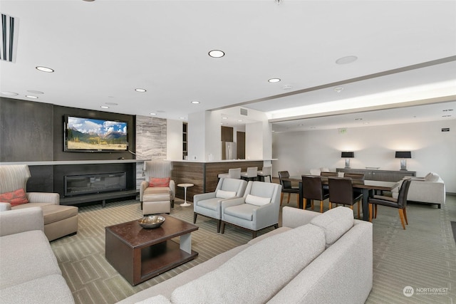 carpeted living room with a large fireplace