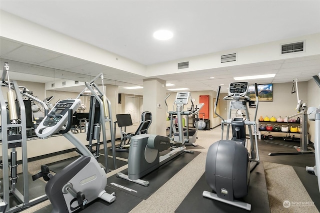 workout area with a paneled ceiling