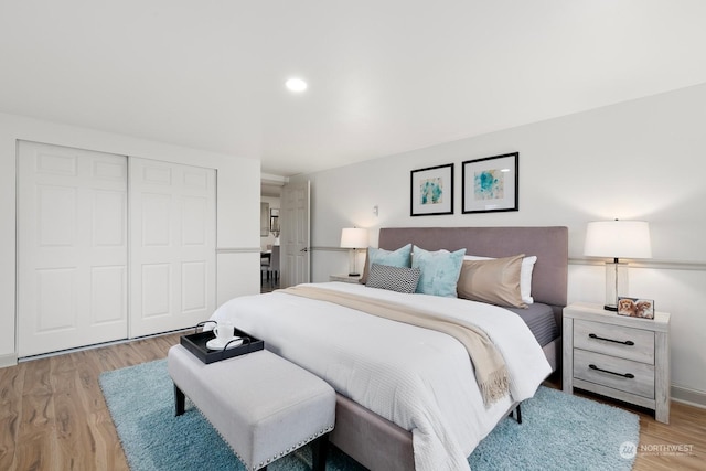 bedroom featuring light hardwood / wood-style flooring and a closet