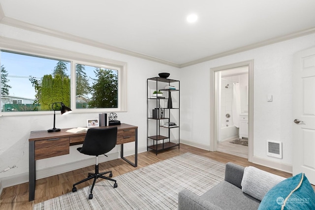 home office featuring hardwood / wood-style floors and crown molding