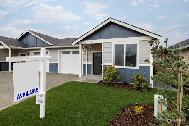 view of front of house with a garage and a front yard