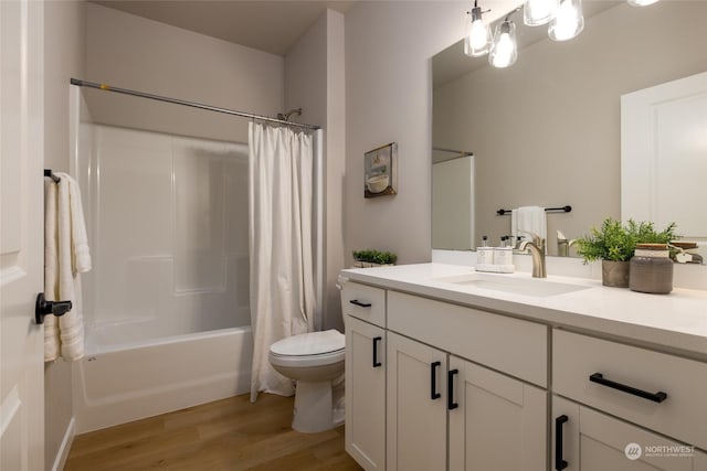 full bathroom featuring vanity, toilet, wood-type flooring, and shower / tub combo