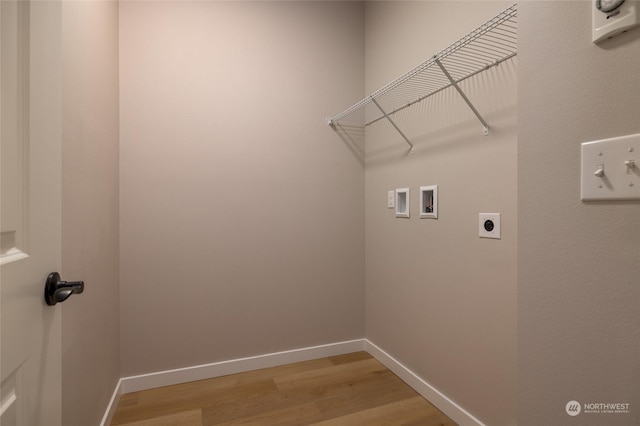 washroom with hookup for an electric dryer, hookup for a washing machine, and light wood-type flooring