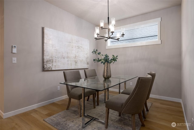 dining room with a notable chandelier and hardwood / wood-style flooring