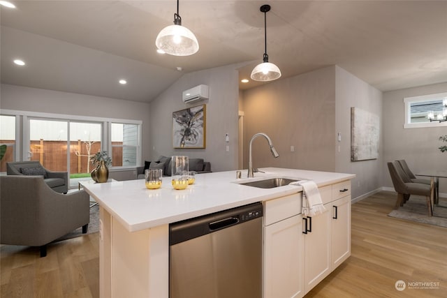 kitchen featuring white cabinets, sink, decorative light fixtures, a center island with sink, and dishwasher