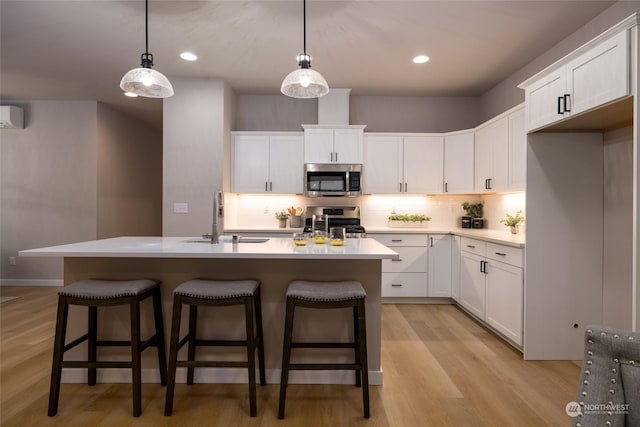 kitchen with sink, white cabinetry, and stainless steel appliances