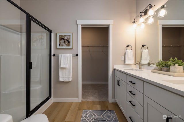 bathroom featuring vanity, an enclosed shower, and hardwood / wood-style flooring