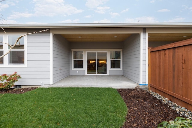 back of house with a yard and a patio