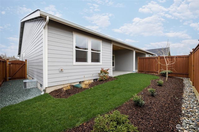 rear view of house featuring a patio area and a yard