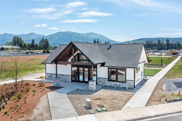 view of front of home with a mountain view and french doors