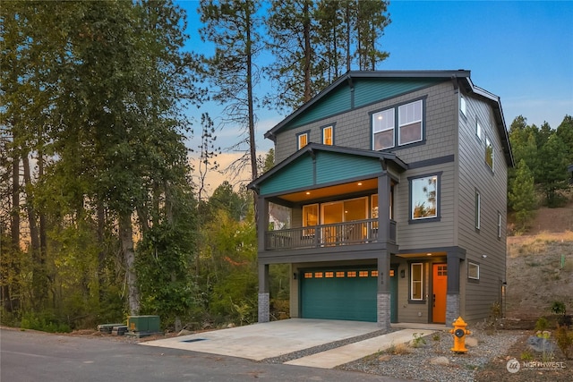 view of front of property featuring a balcony and a garage