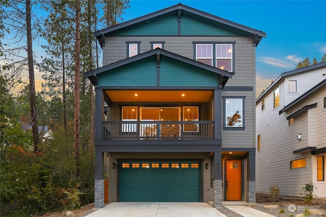 view of front of house with a garage and a balcony